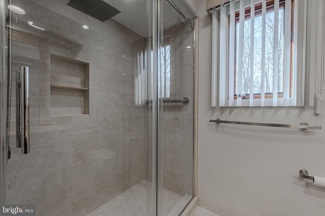 bathroom featuring a shower with shower door