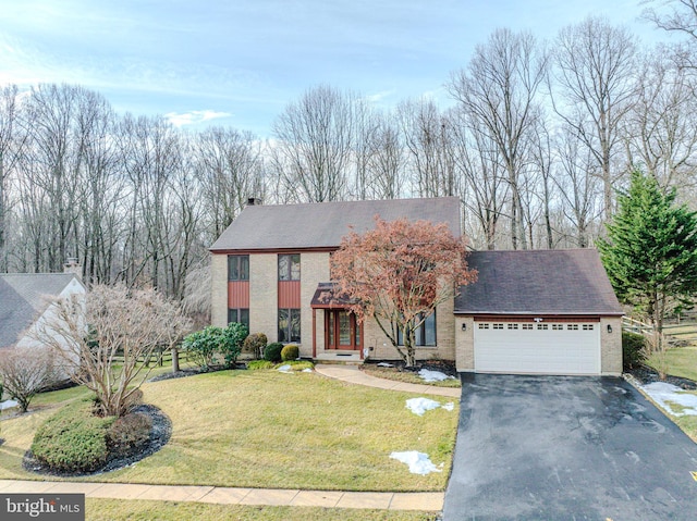 view of front of property with a garage and a front yard