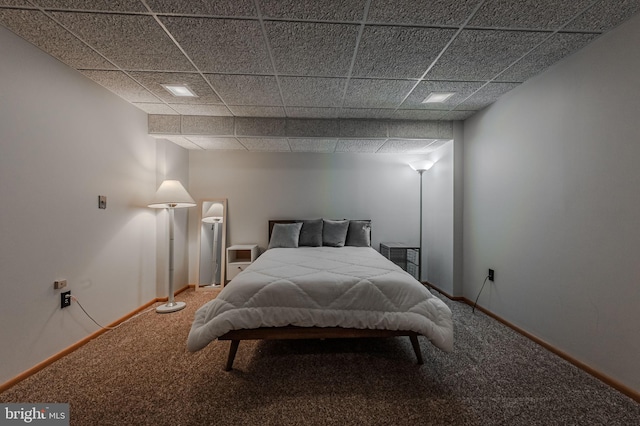 bedroom with a drop ceiling and carpet