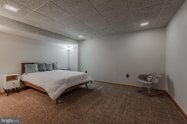 bedroom featuring a paneled ceiling and carpet flooring