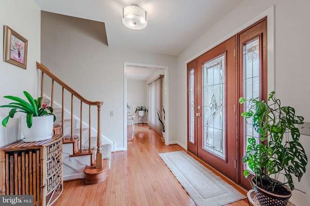 foyer with a healthy amount of sunlight and light hardwood / wood-style floors