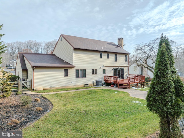 rear view of property featuring a wooden deck, a yard, and central air condition unit