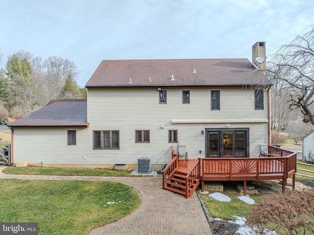 rear view of property with a yard, central AC, and a deck