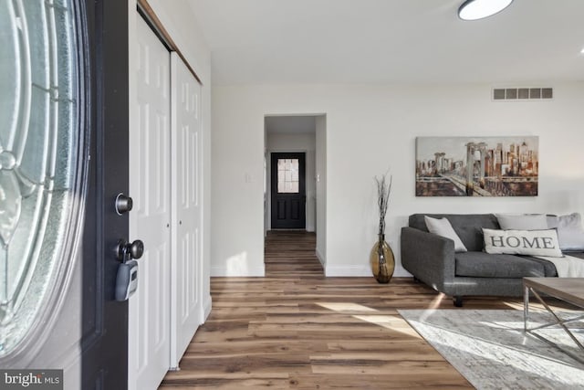 entryway with visible vents, baseboards, and wood finished floors