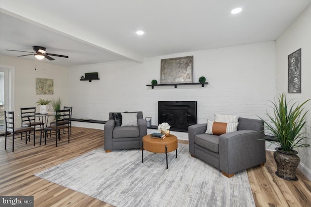 living area featuring recessed lighting, ceiling fan, wood finished floors, beamed ceiling, and baseboards