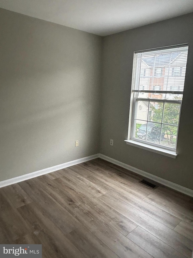 empty room with hardwood / wood-style flooring