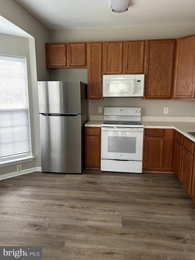 kitchen featuring dark hardwood / wood-style flooring and white appliances