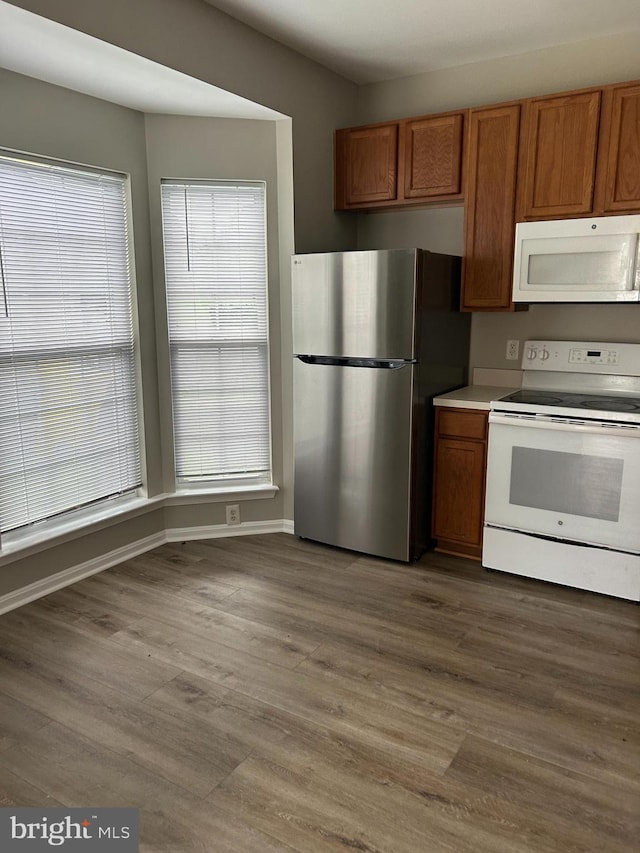 kitchen featuring hardwood / wood-style flooring and white appliances