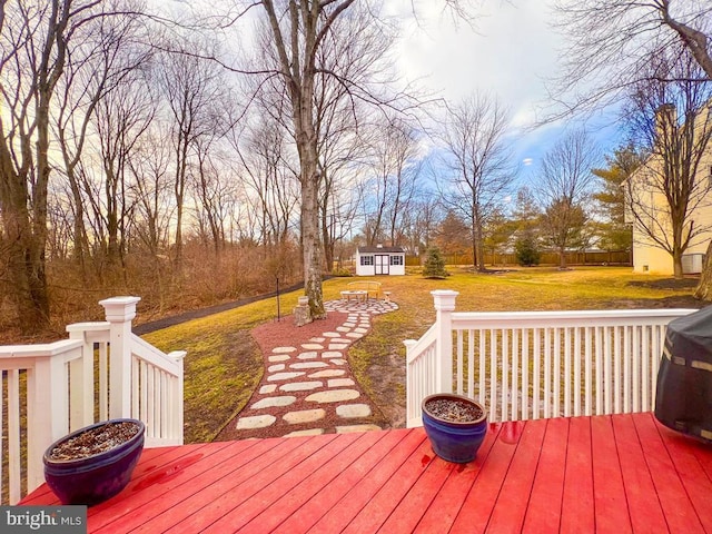 wooden terrace with an outdoor structure and a yard