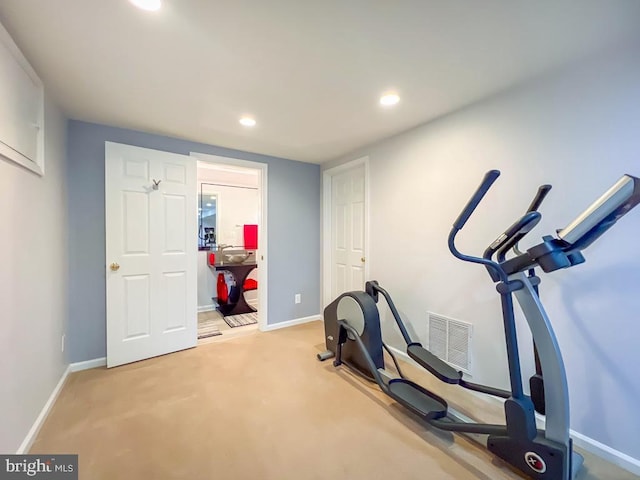 workout area featuring light carpet