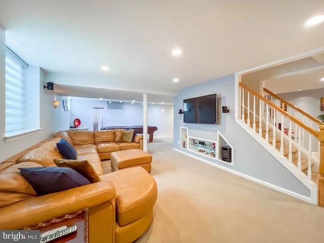 living room featuring carpet floors and an AC wall unit