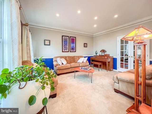 living room with french doors, light colored carpet, and ornamental molding