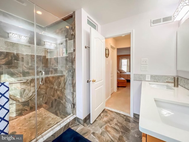 bathroom with vanity and a shower with door