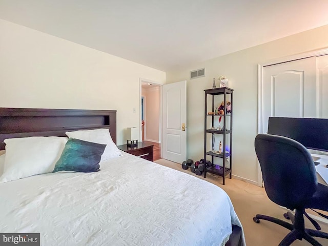 bedroom featuring light carpet and a closet