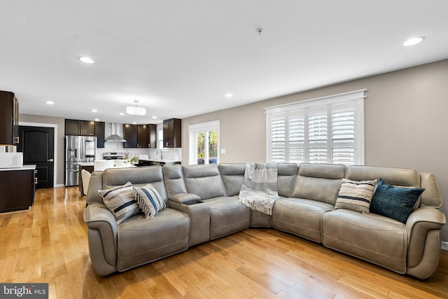 living room with light wood-style floors and recessed lighting