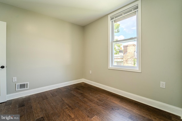 unfurnished room with dark hardwood / wood-style floors