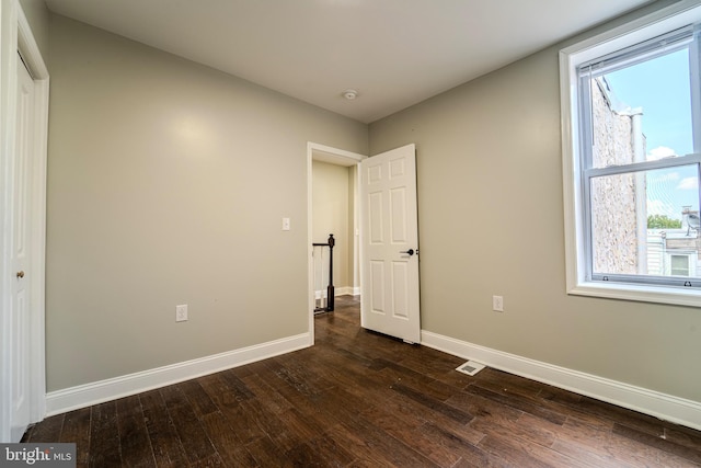 unfurnished bedroom featuring dark hardwood / wood-style flooring