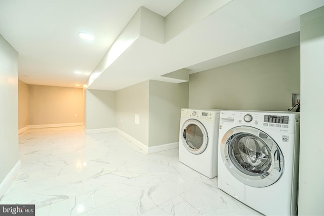 washroom with washing machine and clothes dryer