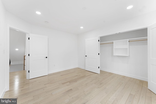 unfurnished bedroom with baseboards, light wood finished floors, and recessed lighting