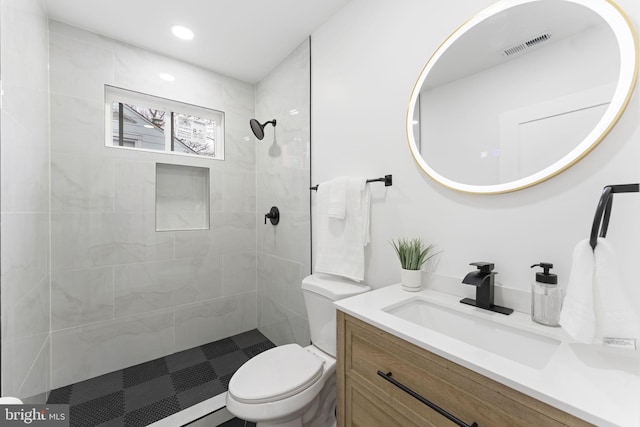full bath featuring toilet, recessed lighting, visible vents, vanity, and tiled shower