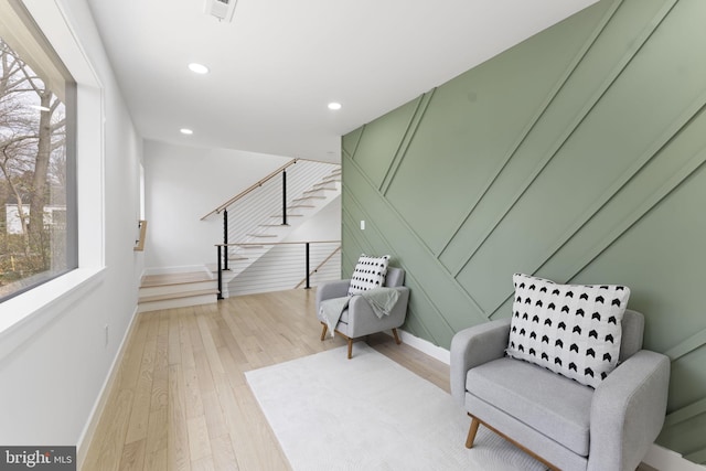 sitting room with baseboards, stairway, light wood-type flooring, and recessed lighting