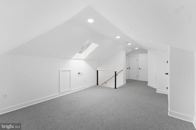 bonus room featuring carpet floors, vaulted ceiling with skylight, baseboards, and recessed lighting