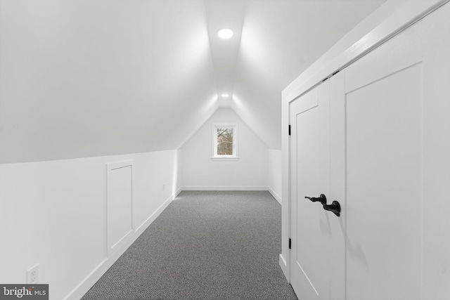 bonus room featuring carpet floors, vaulted ceiling, and baseboards