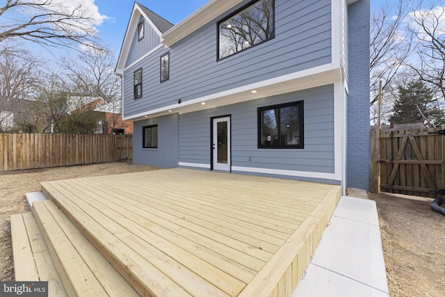 wooden terrace featuring a fenced backyard