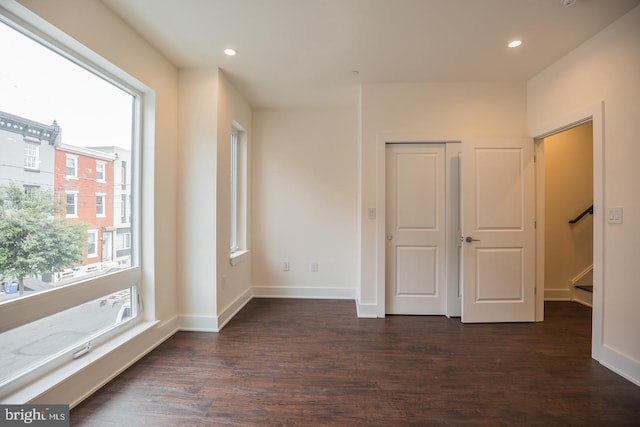 unfurnished bedroom featuring dark hardwood / wood-style flooring and a closet