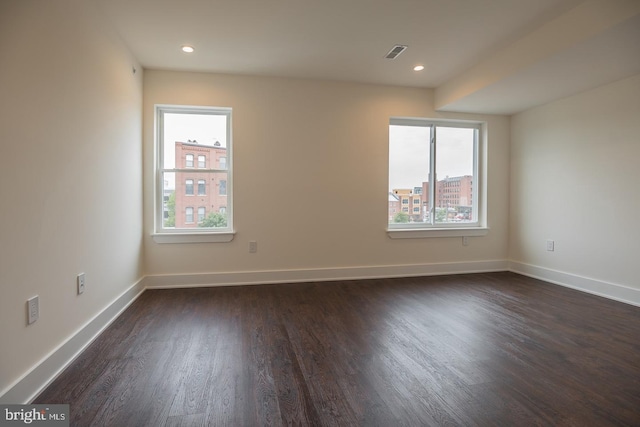 unfurnished room featuring dark hardwood / wood-style floors