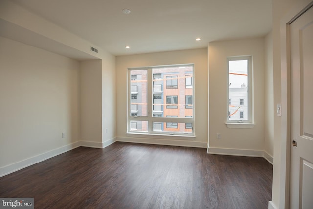 unfurnished room featuring dark wood-type flooring