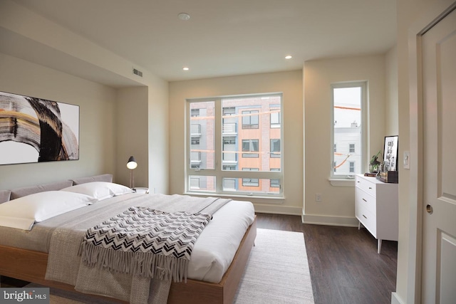 bedroom with dark wood-type flooring