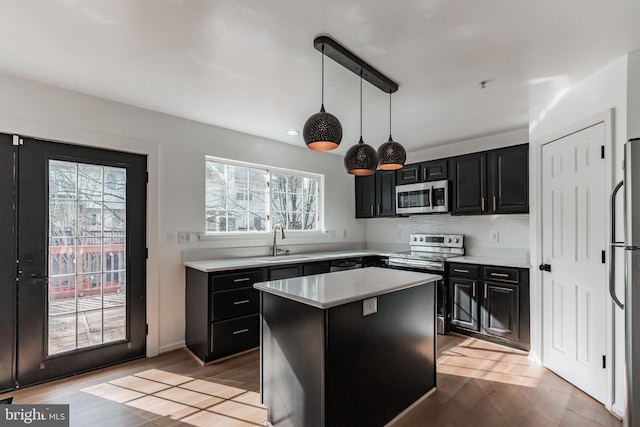 kitchen with sink, a center island, hanging light fixtures, stainless steel appliances, and decorative backsplash