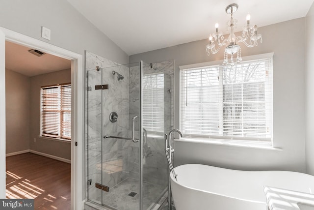 bathroom featuring hardwood / wood-style flooring, lofted ceiling, separate shower and tub, and a notable chandelier