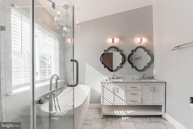 bathroom with vanity, a notable chandelier, and independent shower and bath