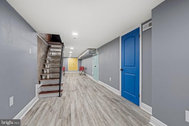 basement with light hardwood / wood-style floors