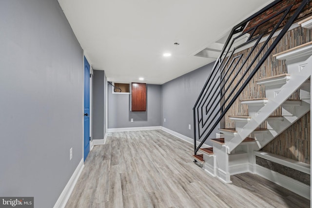 basement with light hardwood / wood-style floors