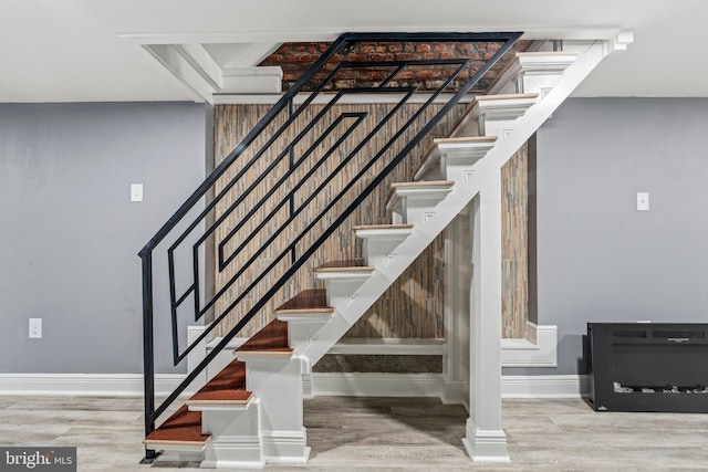 stairs featuring hardwood / wood-style floors