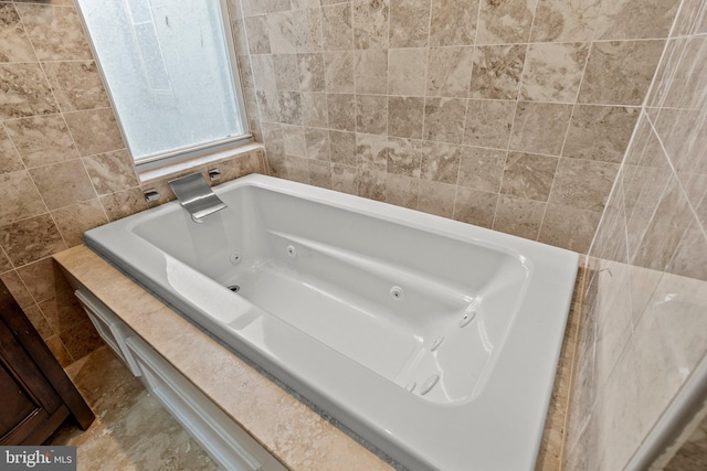 bathroom with a tub and tile walls