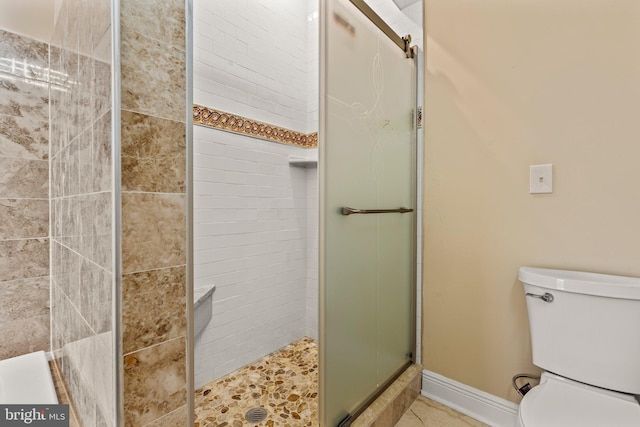 bathroom with an enclosed shower and toilet