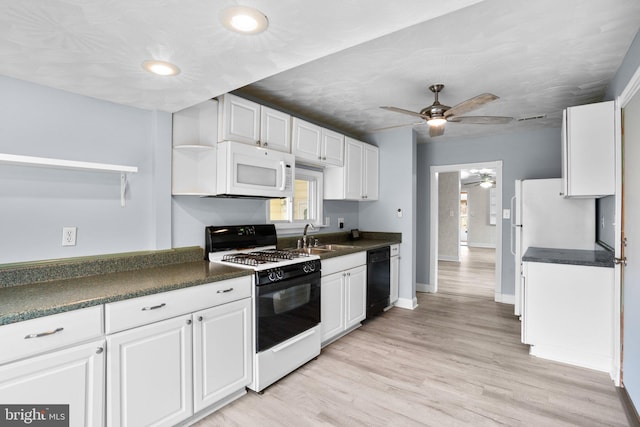 kitchen featuring range with gas stovetop, dark countertops, black dishwasher, and white microwave