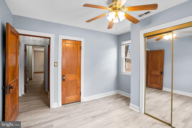 unfurnished bedroom with light wood-style flooring, visible vents, and baseboards