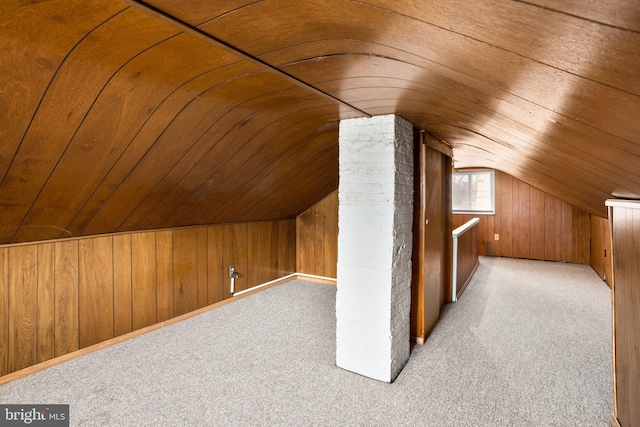 bonus room featuring carpet floors, wood walls, wood ceiling, and vaulted ceiling