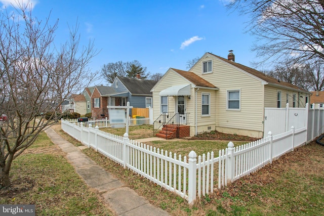 bungalow-style house featuring a fenced front yard, a residential view, and a chimney