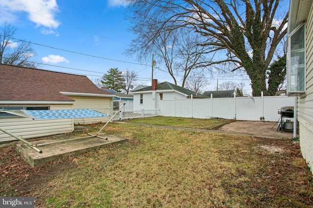 view of yard featuring fence and a patio