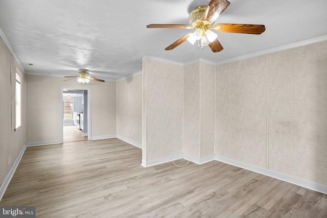 unfurnished room featuring light wood-style floors, crown molding, and baseboards