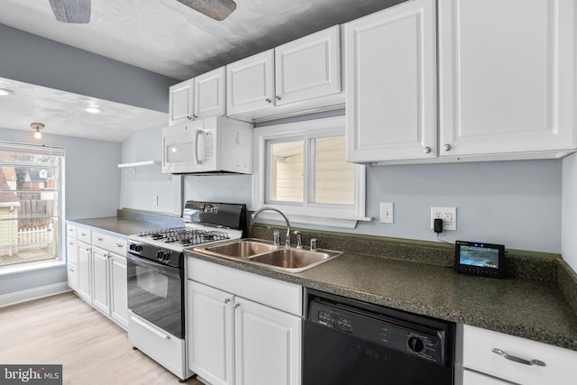 kitchen featuring range with gas cooktop, white microwave, white cabinets, a sink, and dishwasher