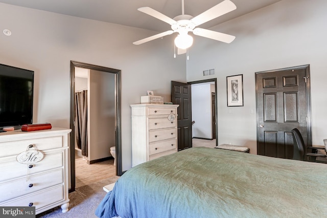 bedroom with ceiling fan, light colored carpet, and high vaulted ceiling