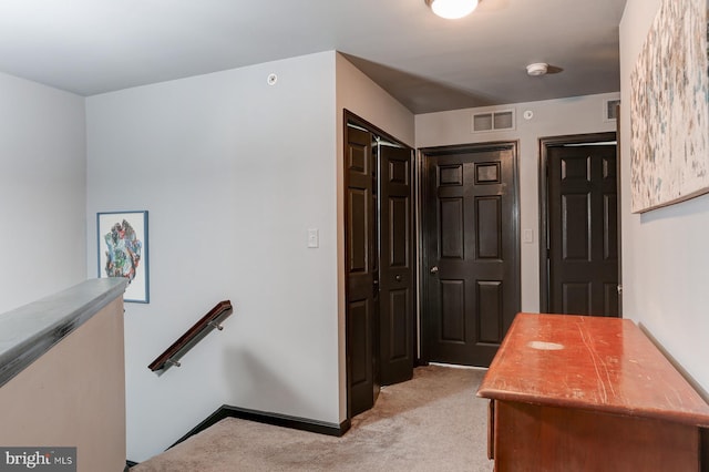 hallway with light colored carpet