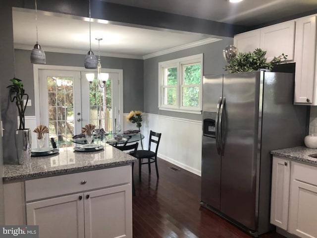 kitchen featuring white cabinetry, stainless steel fridge with ice dispenser, and light stone counters